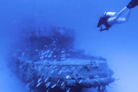 A person scuba diving and observing a St.Croix underwater shipwreck.